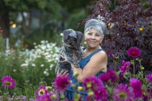 woman and dog posing at All Who Wander Flower Farm