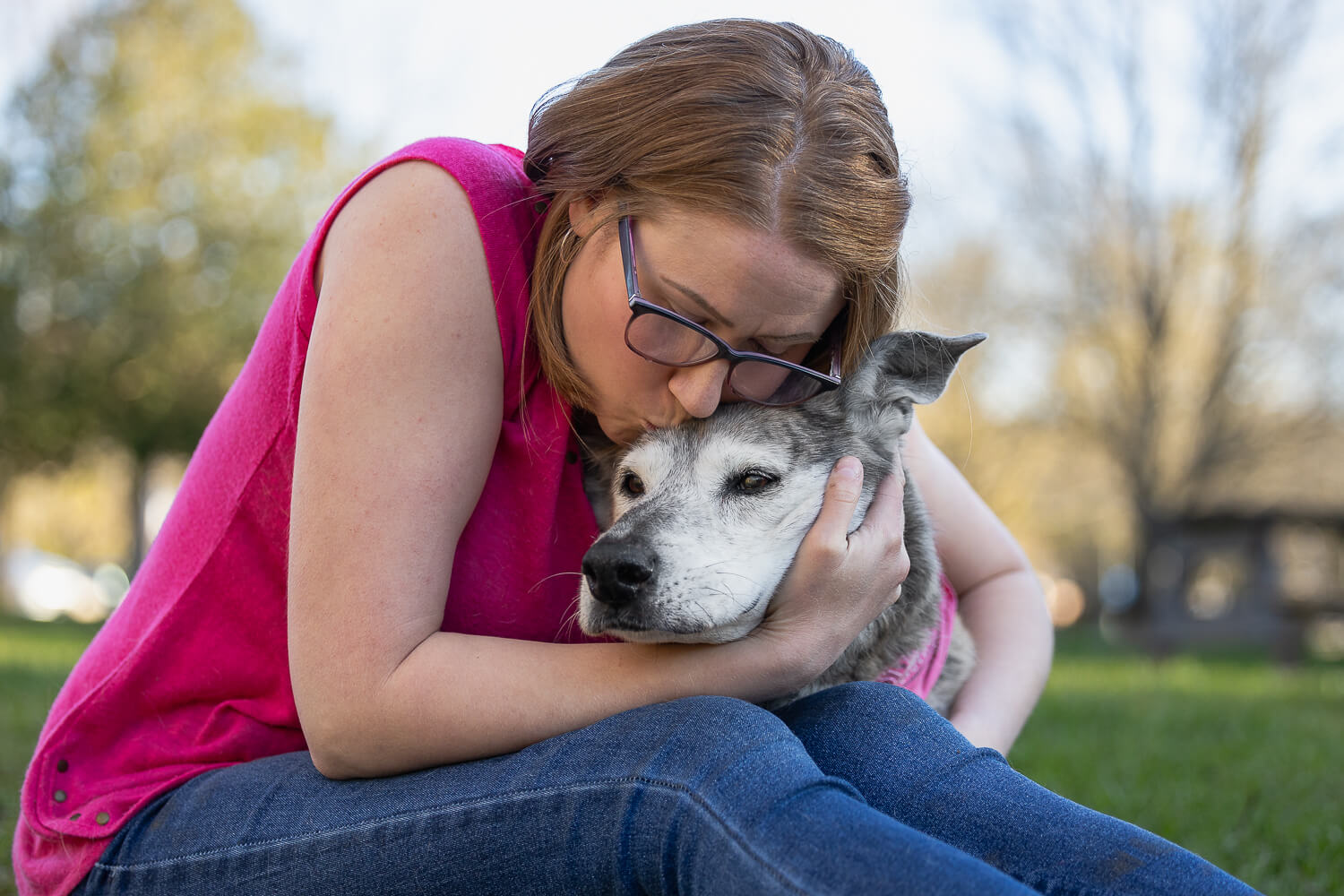 dog and owner photo ideas at Lowville Park Human kissing a dog during a pet photography session in Burlington.