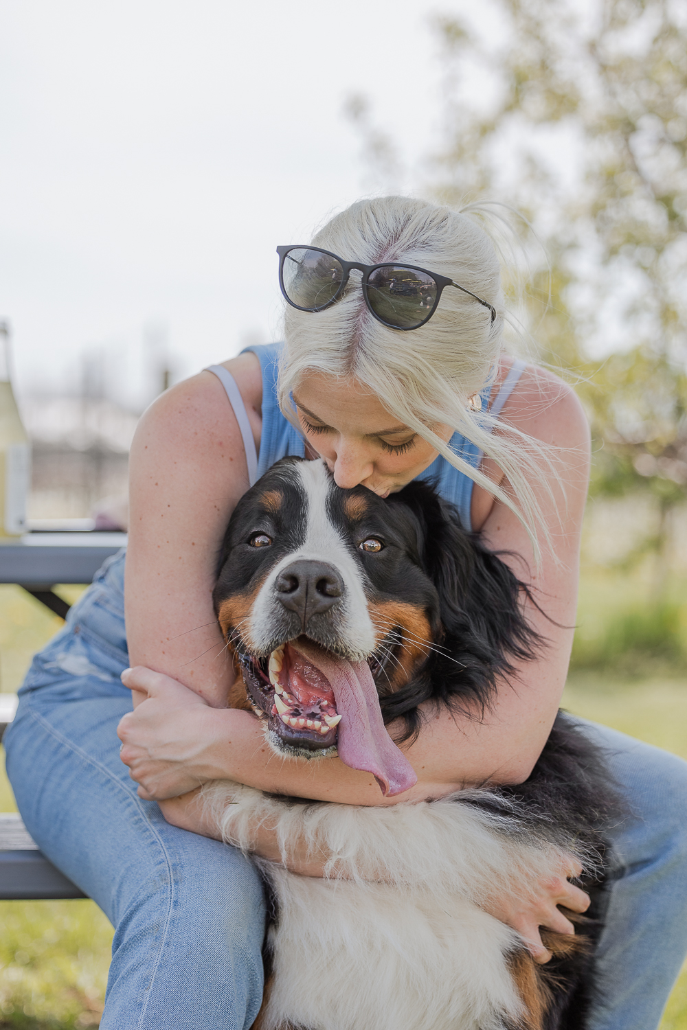 dogs at Hounds Of Erie mom kissing a dog at Hounds Of Erie Winery