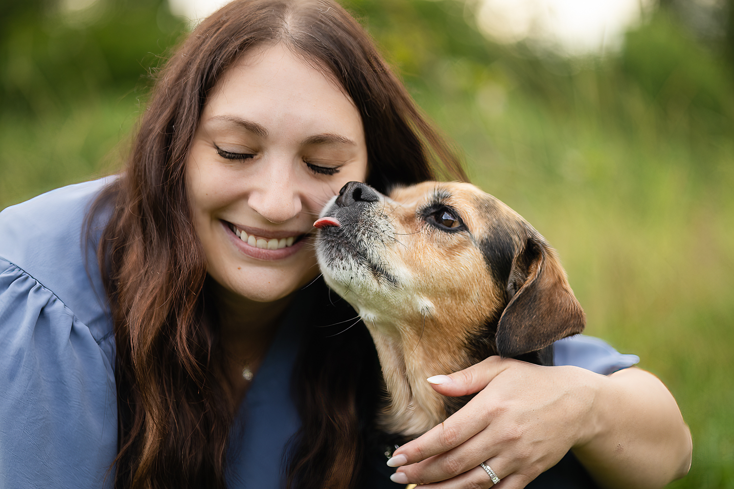 dog kissing their human at a end of life dog photo shoot session Dog kissing dog mom at an end-of-life pet photoshoot session.