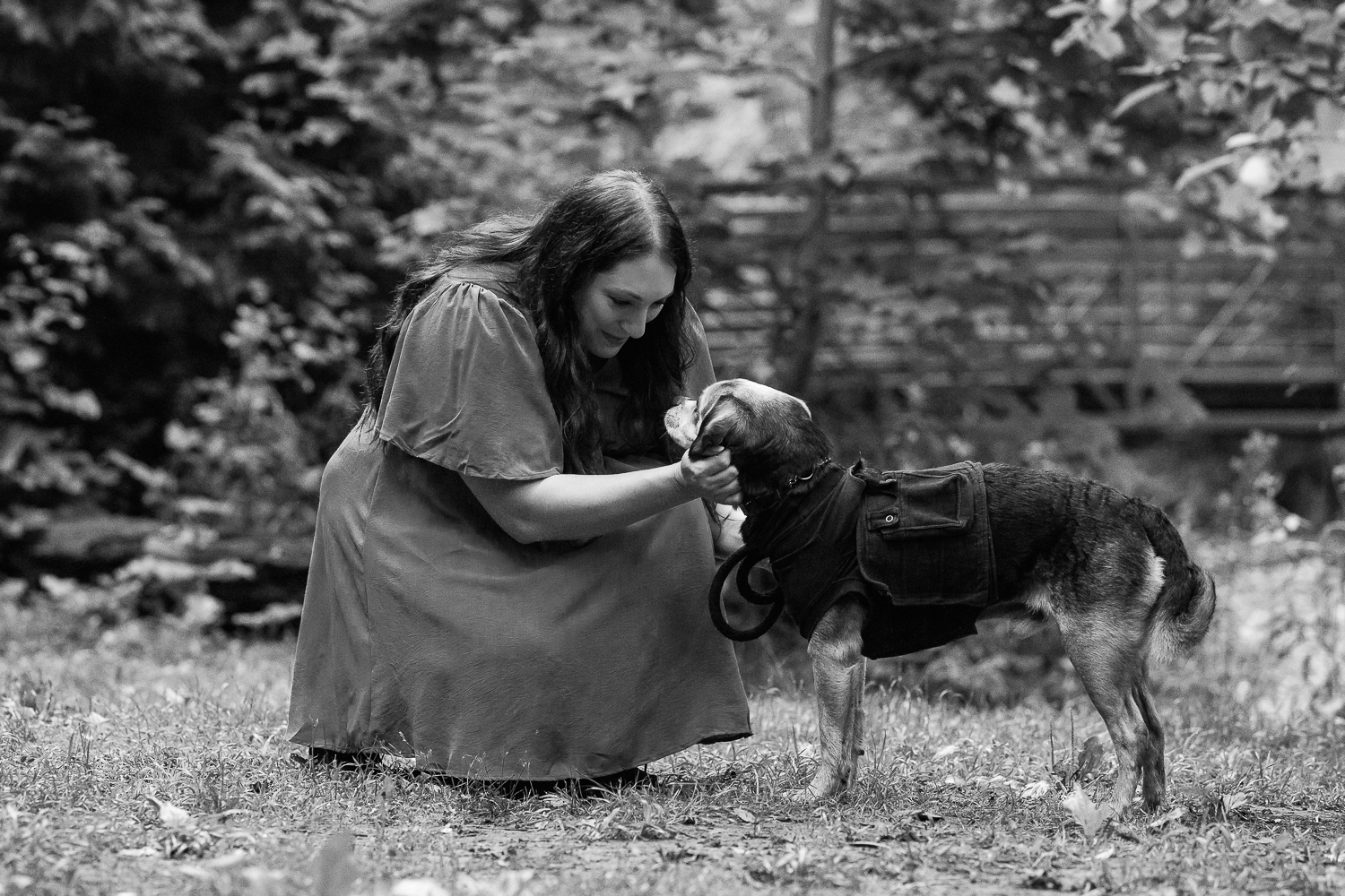 family portraits with pets at Lowville Park Dog mom looking at her heartfelt dog at an end-of-life dog photo session at Lowville Park.