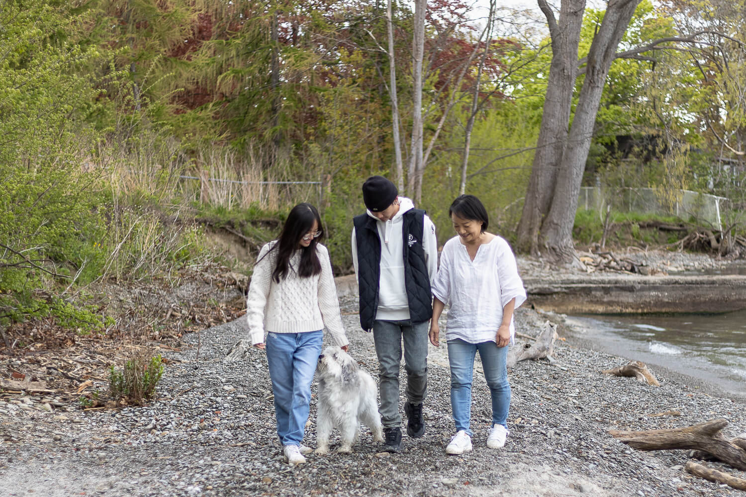 family walking with dog at a photoshoot a family image walking with their dog