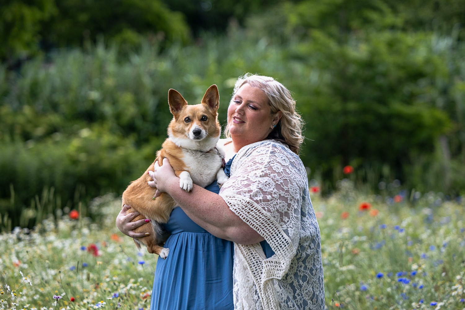 wildflowers mini session a dog mom holding her corgi at a wildflower field in Dundas, ON