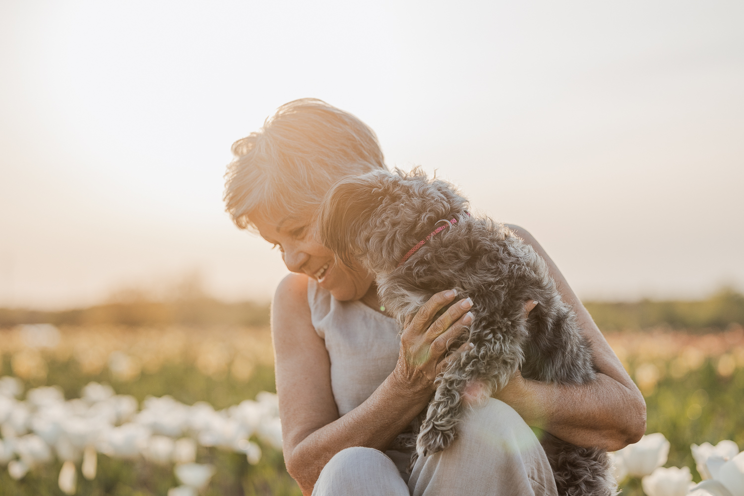 pet and owner posing in while tulips niagara candid moment in a dog photoshoot at TASC